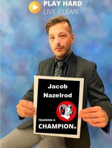 Mr. James holding training a champion sign