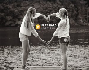 2 girls at a dock on a lake- arms togther to make a heart, PHLC logo 